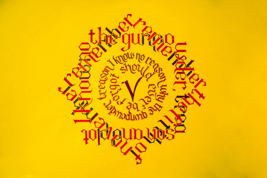 The Fifth of November rhyme in red blackletter, wound into a diamond and a circle around a capital V, on yellow paper.