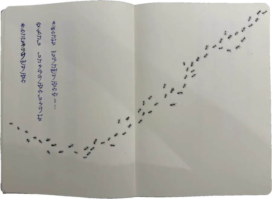 Notebook spread: vertical lines of blue lettering on the left, and a trail of black ants crossing both pages on a diagonal.
